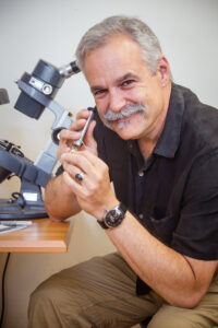 David Lash, GG inspecting gemstones in his state-of-the-art lab in Huntington Village